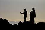 3 people silhouetted, admiring view