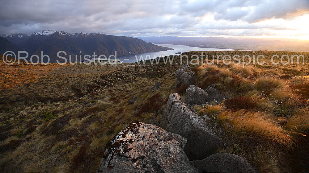 Image of Sunrise on Luxmore Hut, first hut on Kepler Track Great Walk. Lake Te Anau and Murchison Mountains beyond. Dawn, Fiordland National Park, Southland District, Southland Region, New Zealand (NZ) stock photo image