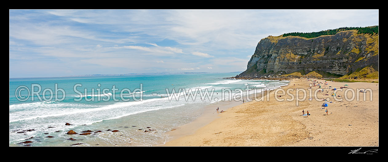 Image of Panorama of people swimming and enjoying the surf on a summers day on Waipatiki Beach, below seacliffs, Waipatiki, Hawke Bay, Hastings District, Hawke's Bay Region, New Zealand (NZ) stock photo image