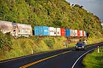 Car driving alongside train