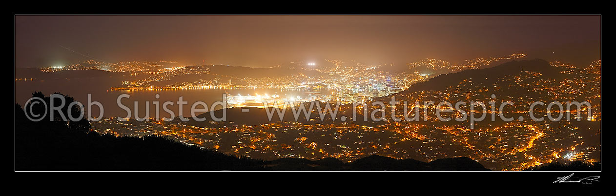 Image of Wellington harbour and city at night from North. Panorama with city lights. Wadestown, Ngaio, CBD, Oriential Bay. Energy consumption, Wellington, Wellington City District, Wellington Region, New Zealand (NZ) stock photo image