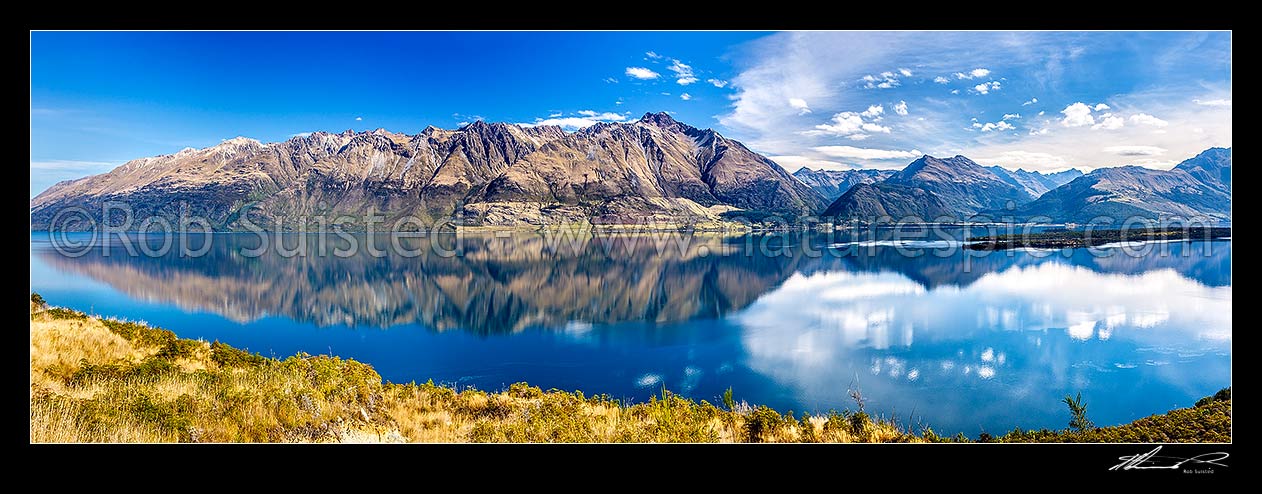 Image of Lake Wakatipu reflecting the Thomson Mountains. Elfin Bay and Greenstone River valley centre right, Pig / Matau Island right. Panorama, Glenorchy, Queenstown Lakes District, Otago Region, New Zealand (NZ) stock photo image