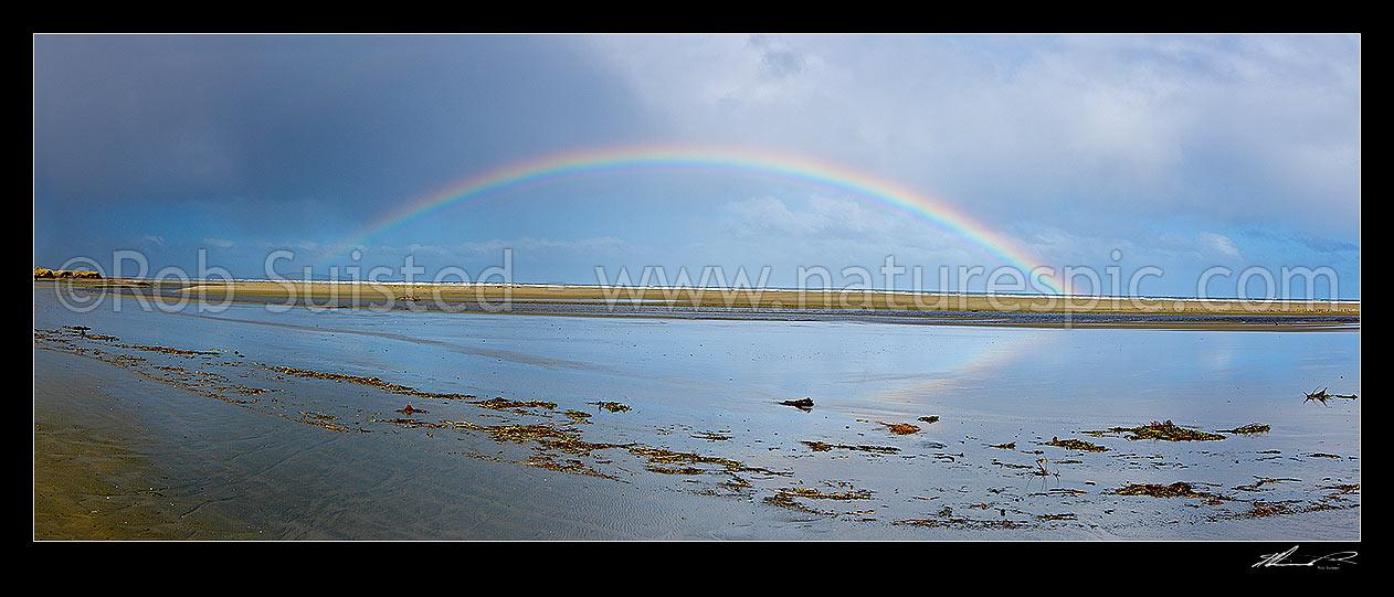 Image of Oreti Beach rainbow arch reflected in Waimatuku Stream mouth, between Invercargill and Riverton. Panorama, Oreti Beach, Southland District, Southland Region, New Zealand (NZ) stock photo image