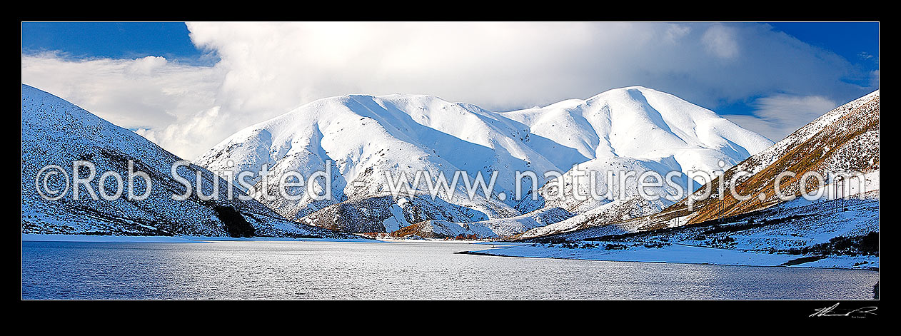 Image of Lake Lyndon with Torlesse Range beyond in heavy winter snowfall. Panorama, Porters Pass, Selwyn District, Canterbury Region, New Zealand (NZ) stock photo image