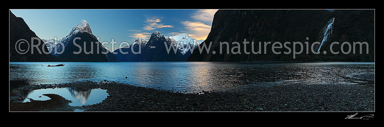 Image of Mitre Peak reflecting in Milford Sound. Mitre Peak left (1683m), The Lion (1302m) and Mt Pembroke (2015m) centre. Panorama at dawn, Milford Sound, Fiordland National Park, Southland District, Southland Region, New Zealand (NZ) stock photo image