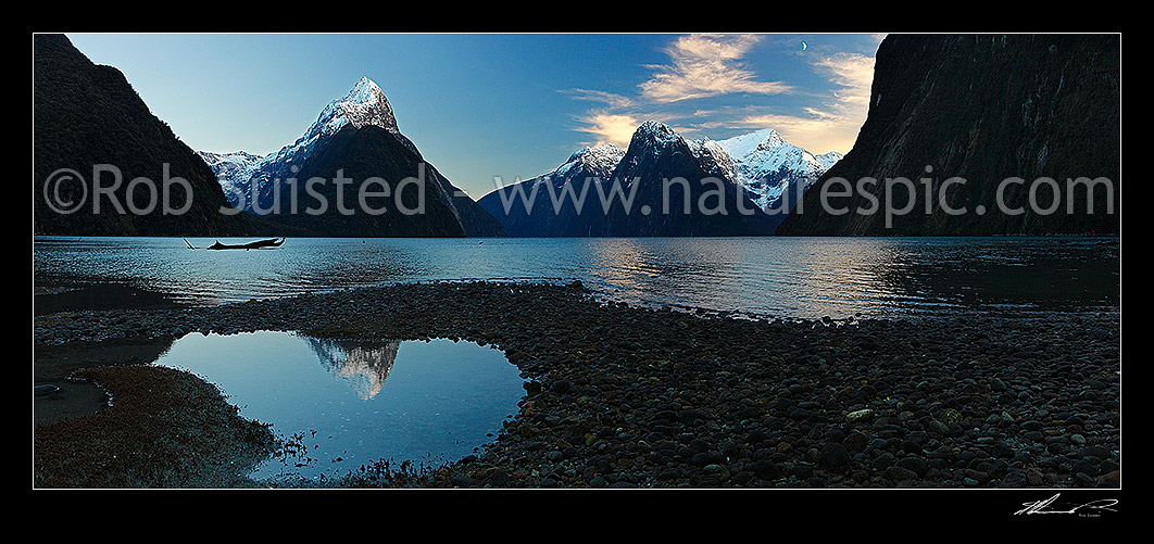 Image of Mitre Peak reflecting in Milford Sound Fiordland. Mitre Peak left (1683m), The Lion (1302m) and Mt Pembroke (2015m) centre right. Panorama at dawn with moon, Milford Sound, Fiordland National Park, Southland District, Southland Region, New Zealand (NZ) stock photo image