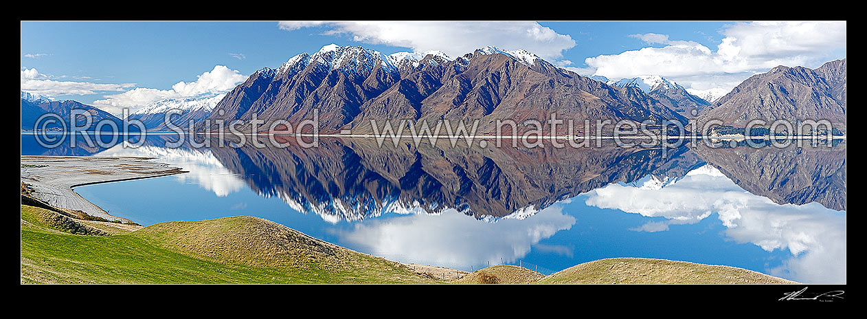 Image of Lake Hawea on a perfect calm spring/winter day reflecting the surrounding snowy ranges. Panorama, Hawea, Queenstown Lakes District, Otago Region, New Zealand (NZ) stock photo image