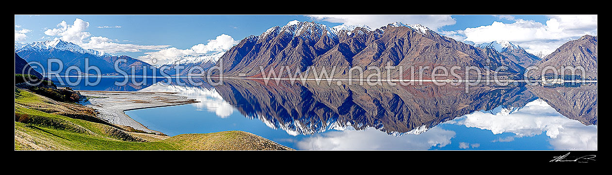 Image of Lake Hawea on a perfect calm spring/winter day reflecting the surrounding snowy ranges. Panorama, Hawea, Queenstown Lakes District, Otago Region, New Zealand (NZ) stock photo image