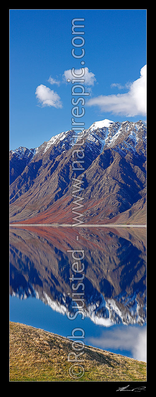 Image of Lake Hawea on a perfect calm spring/winter day reflecting the surrounding snowy ranges. Vertical panorama, Hawea, Queenstown Lakes District, Otago Region, New Zealand (NZ) stock photo image