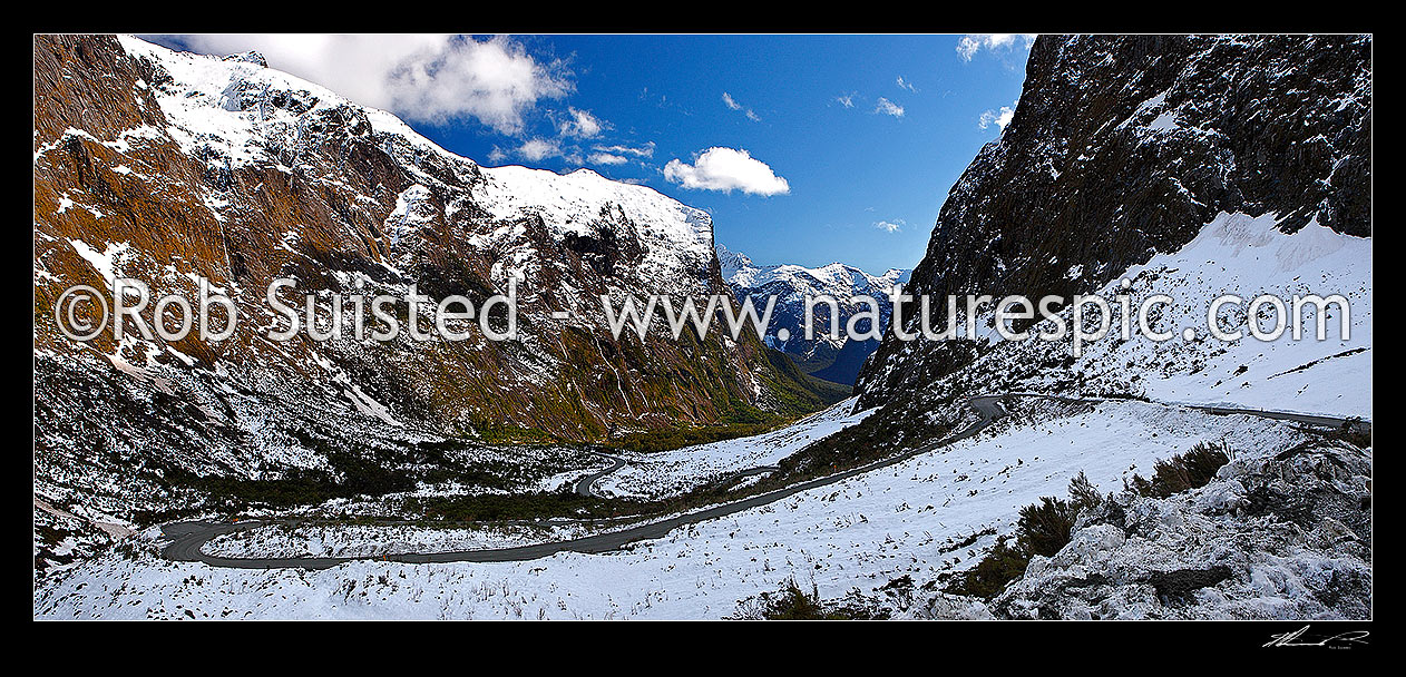 Image of Milford Sound Road, looking down the Cleddau Valley from Homer Tunnel, Darran Mountains. State Highway 94 in winter. Sheerdown Hills in centre distance. Panorama, Milford Sound, Fiordland National Park, Southland District, Southland Region, New Zealand (NZ) stock photo image