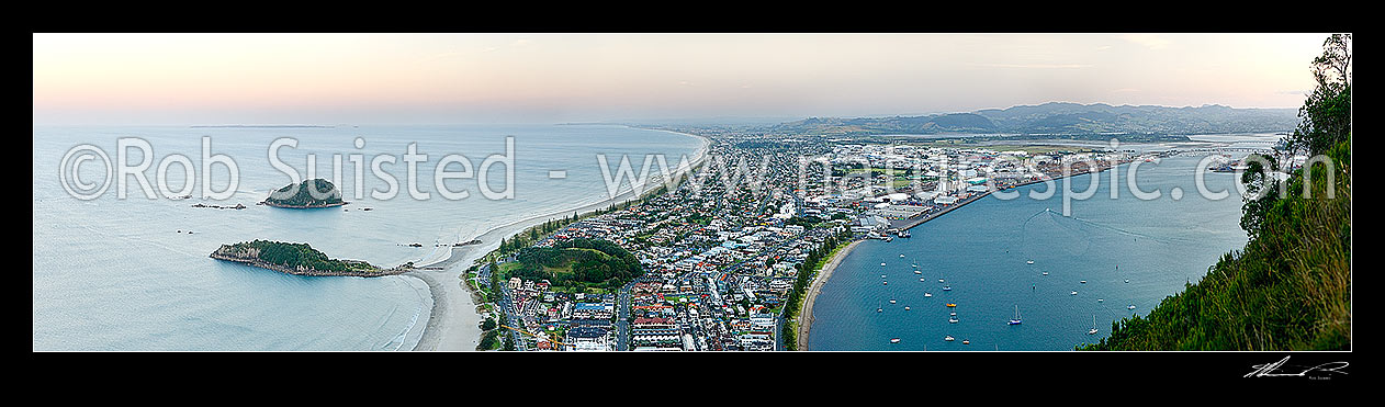 Image of View from Mt Maunganui (232m) Mauao, over beach and Moturiki and Motuotau Islands, towards Papamoa, Tauranga Harbour right. Panorama at dusk, Mount Maunganui, Tauranga District, Bay of Plenty Region, New Zealand (NZ) stock photo image