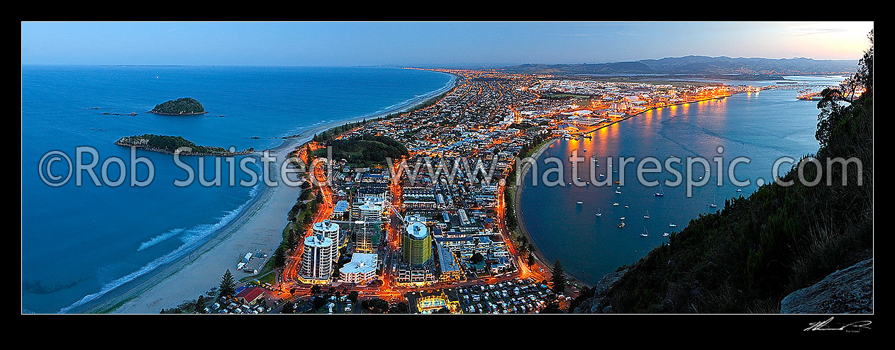 Image of View from Mt Maunganui (232m) Mauao, over beach and Moturiki and Motuotau Islands, towards Papamoa, Tauranga Harbour right. Night time panorama after dusk, Mount Maunganui, Tauranga District, Bay of Plenty Region, New Zealand (NZ) stock photo image