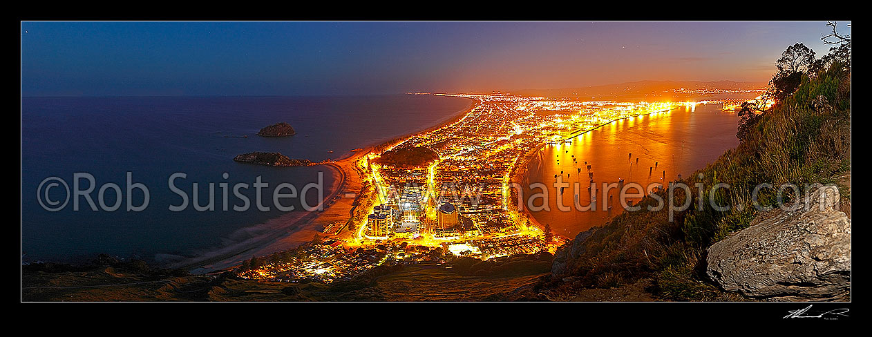 Image of View from Mt Maunganui (232m) over beach and Moturiki and Motuotau Islands, towards Papamoa, night time panorama. Tauranga Harbour right., Mount Maunganui, Tauranga District, Bay of Plenty Region, New Zealand (NZ) stock photo image