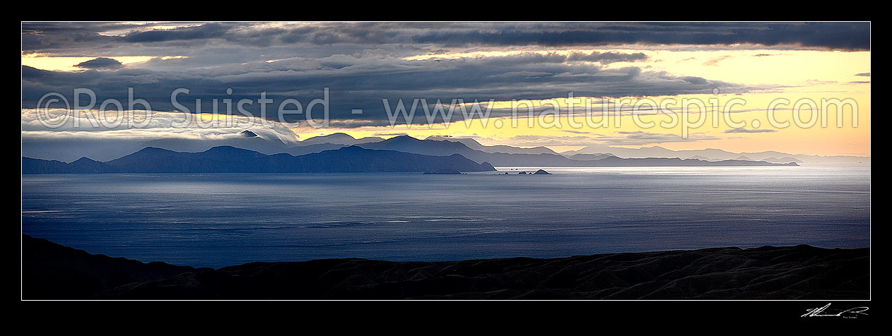 Image of Cook Strait evening panorama. Looking West towards Marlborough Sounds, Mount Stokes in cloud, The Brothers Islands (centre) and Cape Jackson (left), Cook Strait, Wellington City District, Wellington Region, New Zealand (NZ) stock photo image