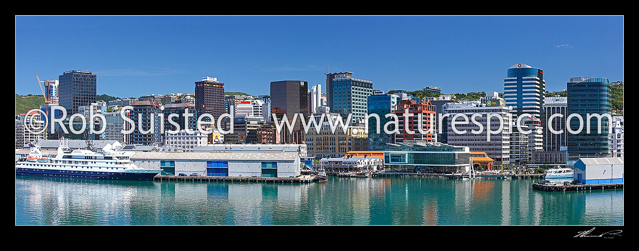 Image of Wellington City skyline panorama from a Cook Strait ferry departing the capital city. MV Orion berthed at Queens Wharf, Wellington City, Wellington City District, Wellington Region, New Zealand (NZ) stock photo image