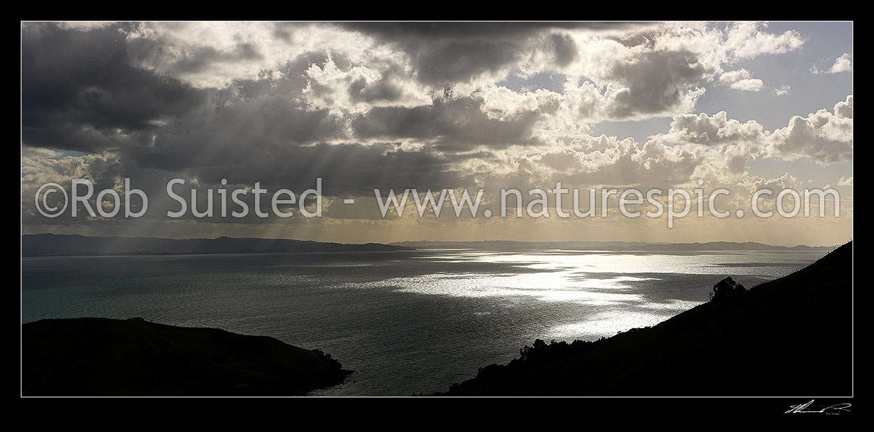 Image of Hauraki Gulf panorama. Moody sunshafts and clouds over sea near Kirita Bay, Coromandel Peninsula, looking towards Auckland, Coromandel, Thames-Coromandel District, Waikato Region, New Zealand (NZ) stock photo image