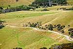 Gravel road passing through farmland