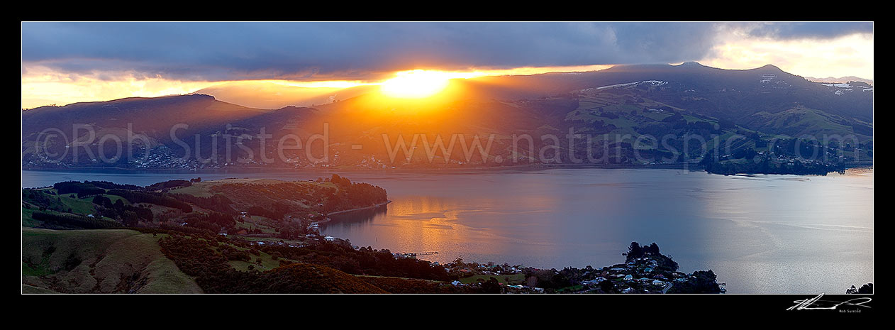 Image of Otago Harbour sunset over Broad Bay, Mount Cargill beyond. Winter panorama, Otago Peninsula, Dunedin City District, Otago Region, New Zealand (NZ) stock photo image