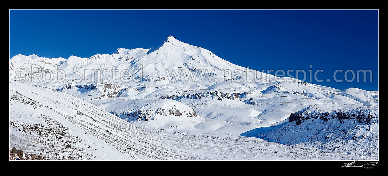 Image of Mount Ruapehu above Rangipo desert in winter snow. Te Heuheu peak (2734m) centre & Mangatoetoenui stream. Round the Mountain (Mt Ruapehu) Track, Tongariro National Park, Ruapehu District, Manawatu-Wanganui Region, New Zealand (NZ) stock photo image