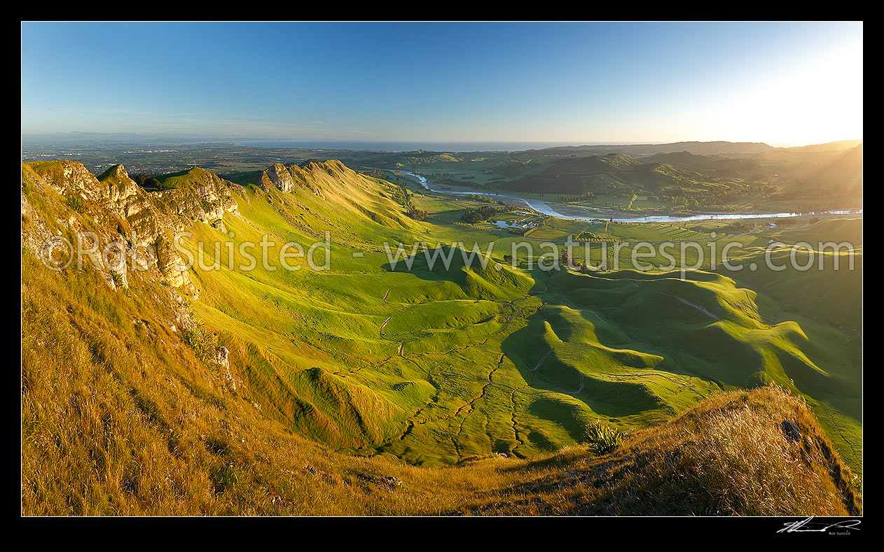 Image of Sunrise on Te Mata Peak (399m). Overlooking Hawke Bay and the Tukituki River with Napier far left. Panorama, Hawke's Bay, Hastings District, Hawke's Bay Region, New Zealand (NZ) stock photo image