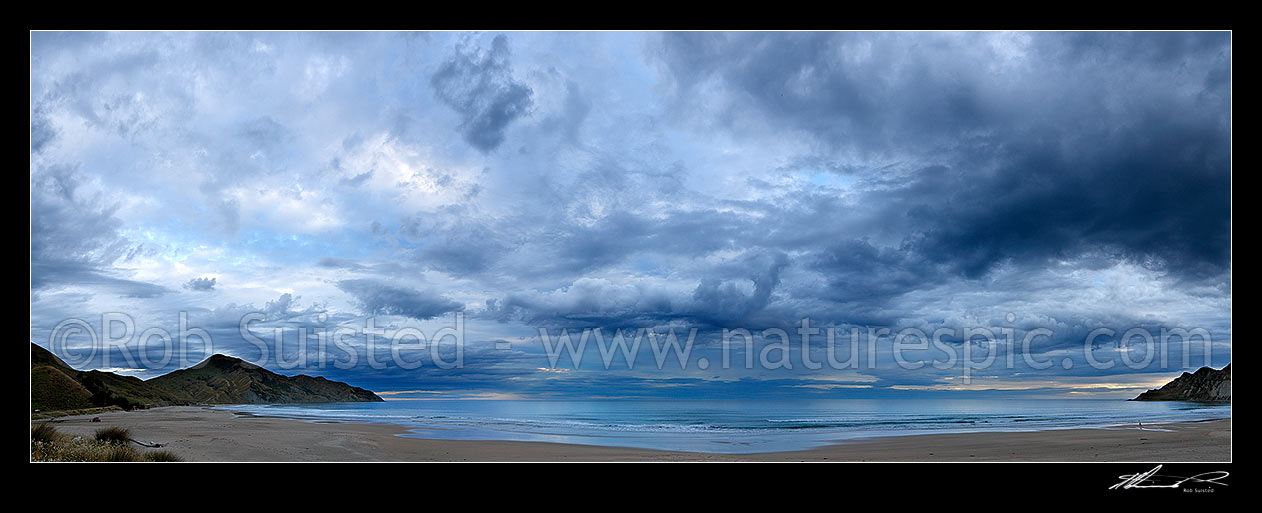 Image of Kaiaua Bay Beach moody twilight panorama, as storm clouds gather, with Marau Point left and Te Karaka Point right, Tolaga Bay, Gisborne District, Gisborne Region, New Zealand (NZ) stock photo image