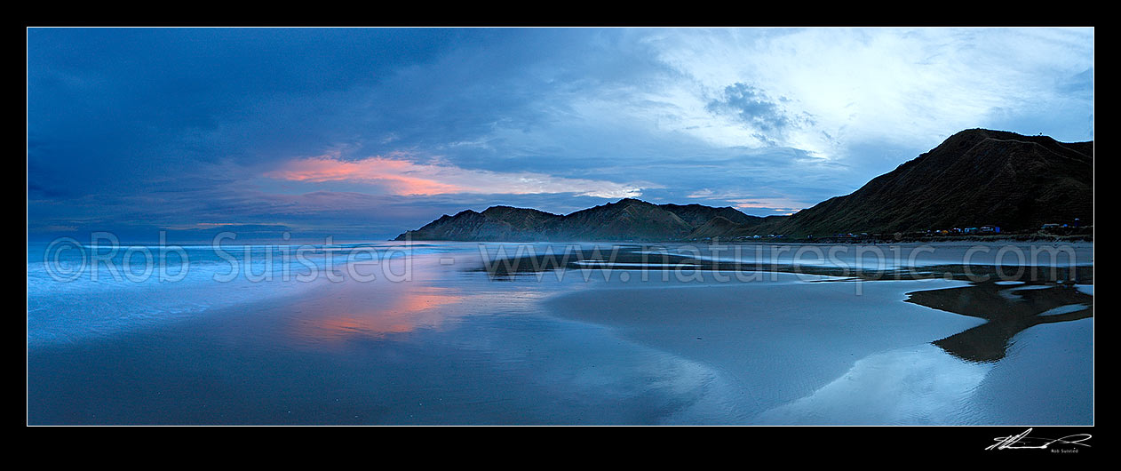 Image of Kaiaua Bay Beach moody sunset panorama, as storm clouds gather, with Te Karaka Point centre, Tolaga Bay, Gisborne District, Gisborne Region, New Zealand (NZ) stock photo image