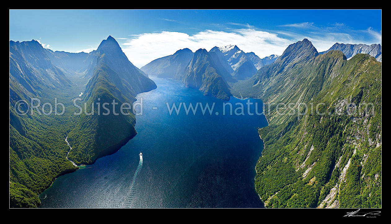 Image of Looking down Milford Sound / Piopiotahi from near head. Sinbad Gully and Mitre Peak (1683m) left, The Lion (1302m), Mount Pembroke (2015m) centre, and Harrison Cove and Mills Peak right. Aerial panorama, Milford Sound, Fiordland National Park, Southland District, Southland Region, New Zealand (NZ) stock photo image