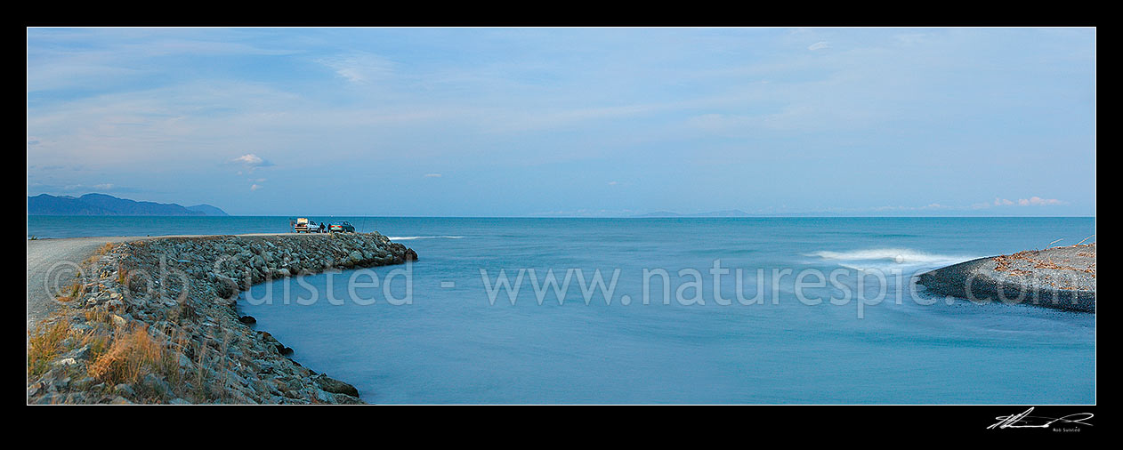 Image of Wairau River mouth and bar panorama. Cars and fishermen fishing at dusk. Cloudy Bay and North Island beyond, Blenheim, Marlborough District, Marlborough Region, New Zealand (NZ) stock photo image