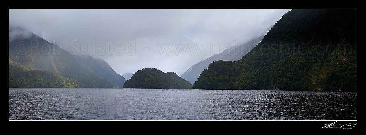 Image of Doubtful Sound on a misty day. Looking down sound past Elizabeth Island and Brig Point towards open sea, Doubtful Sound, Fiordland National Park, Southland District, Southland Region, New Zealand (NZ) stock photo image