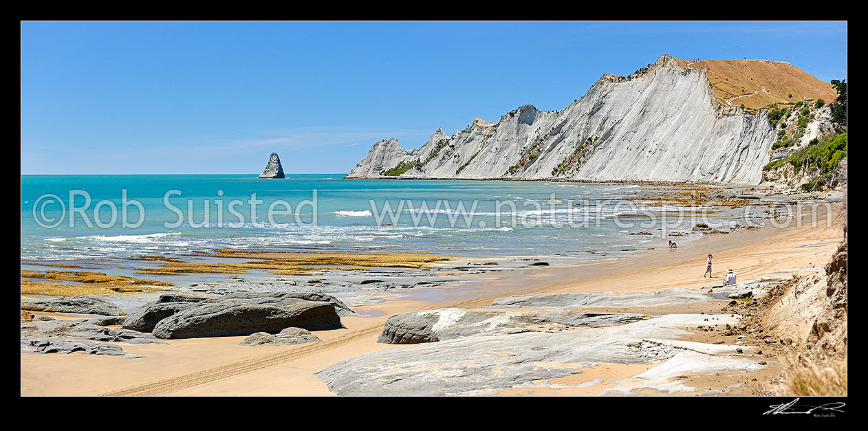 Image of Cape Kidnappers headland panorama with a young family enjoying the beach, Hawke's Bay, Hastings District, Hawke's Bay Region, New Zealand (NZ) stock photo image