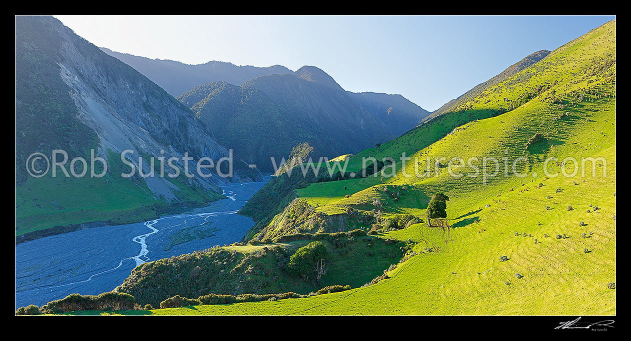 Image of Mukamuka Stream and Wharekauhau Station farmland beside the Remutaka (Rimutaka) Forest Park. South Saddle visible centre. Panorama, Palliser Bay, South Wairarapa District, Wellington Region, New Zealand (NZ) stock photo image