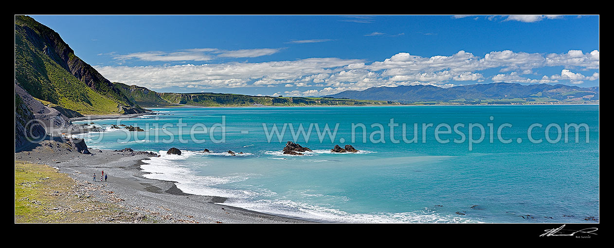 Image of Palliser Bay coast panorama looking towards Ocean Beach with a family walking on the beach. Aorangi Haurangi Range beyond, Ocean Beach, South Wairarapa District, Wellington Region, New Zealand (NZ) stock photo image