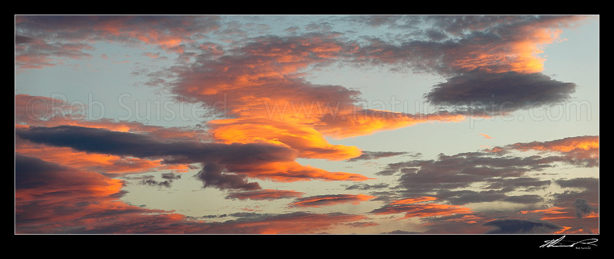 Image of Unusual fiery orange sunset clouds in an evening sky. Panorama file, New Zealand (NZ) stock photo image