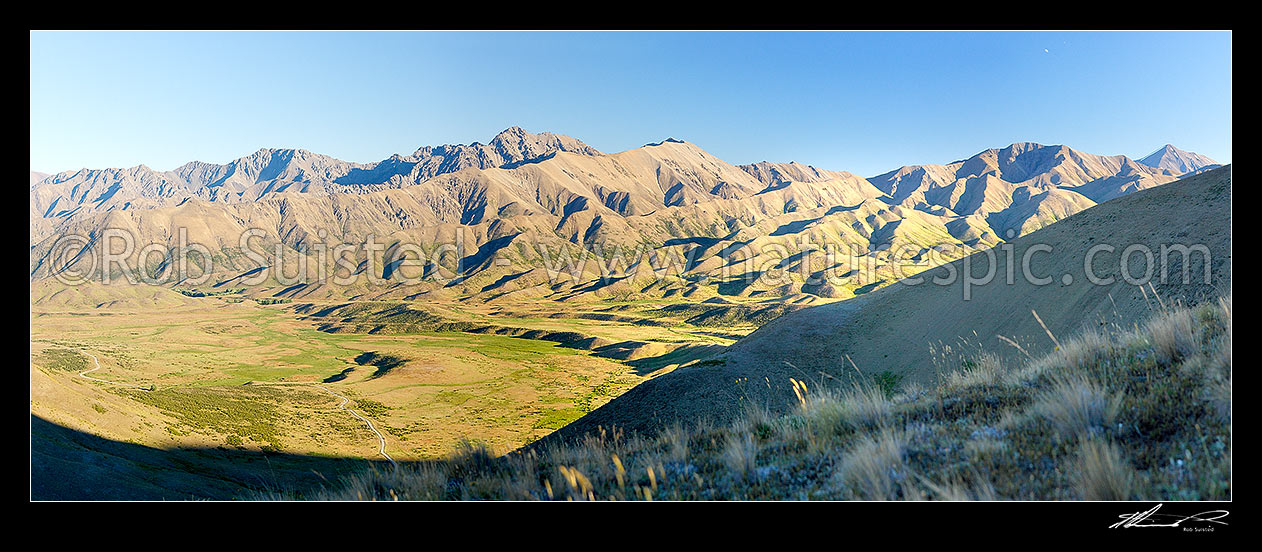 Image of Molesworth Station Road in the upper Awatere River valley. Turks Head (1958m) and Inland Kaikoura Range beyond. Panorama, Molesworth Station, Marlborough District, Marlborough Region, New Zealand (NZ) stock photo image