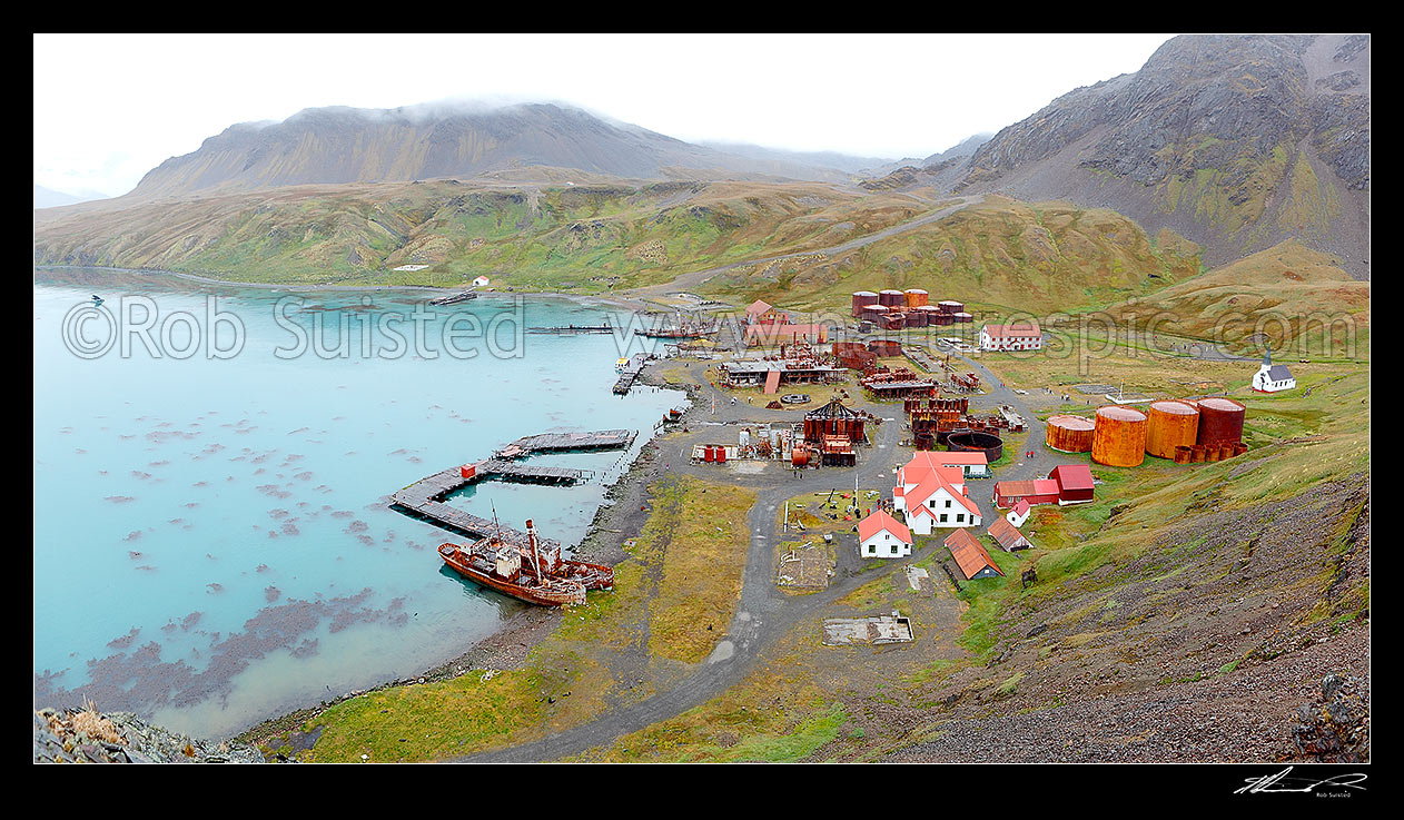 Image of Grytviken whaling station remains in King Edward Cove. Whaling boats 'Dias' and 'Albatross' and museum foreground, and whalers church at left. Panorama, King Edward Cove, South Georgia stock photo image