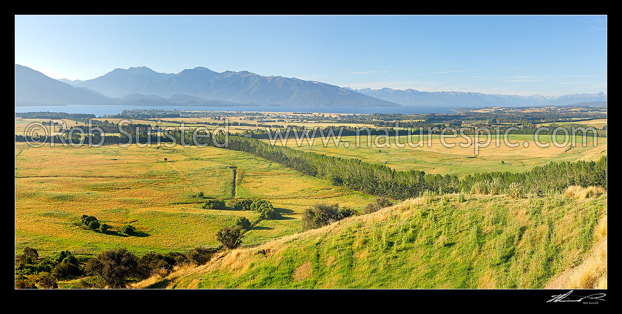 Image of Farmland with Lake Te Anau and Fiordland mountains and National Park behind. Panorama, Te Anau, Southland District, Southland Region, New Zealand (NZ) stock photo image