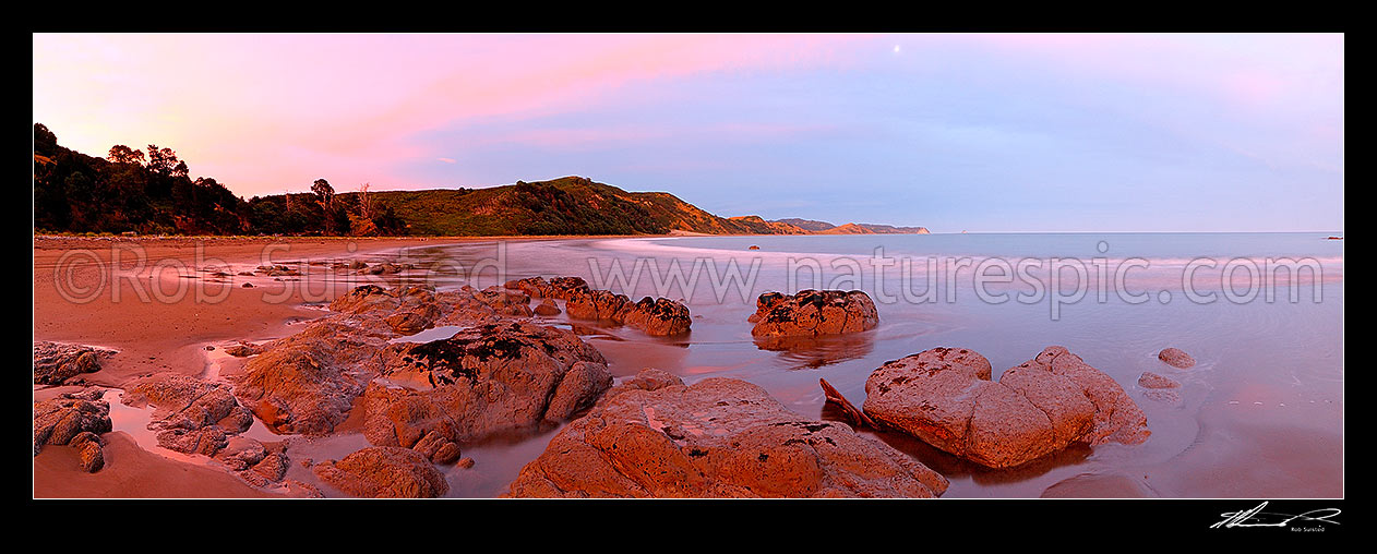 Image of Sunset at Port Awanui with Te Wharau Beach beyond. Whakaumu Peak, East Cape and East Island (Whangaokeno) visible in distance. Panorama, Port Awanui, East Coast, Gisborne District, Gisborne Region, New Zealand (NZ) stock photo image