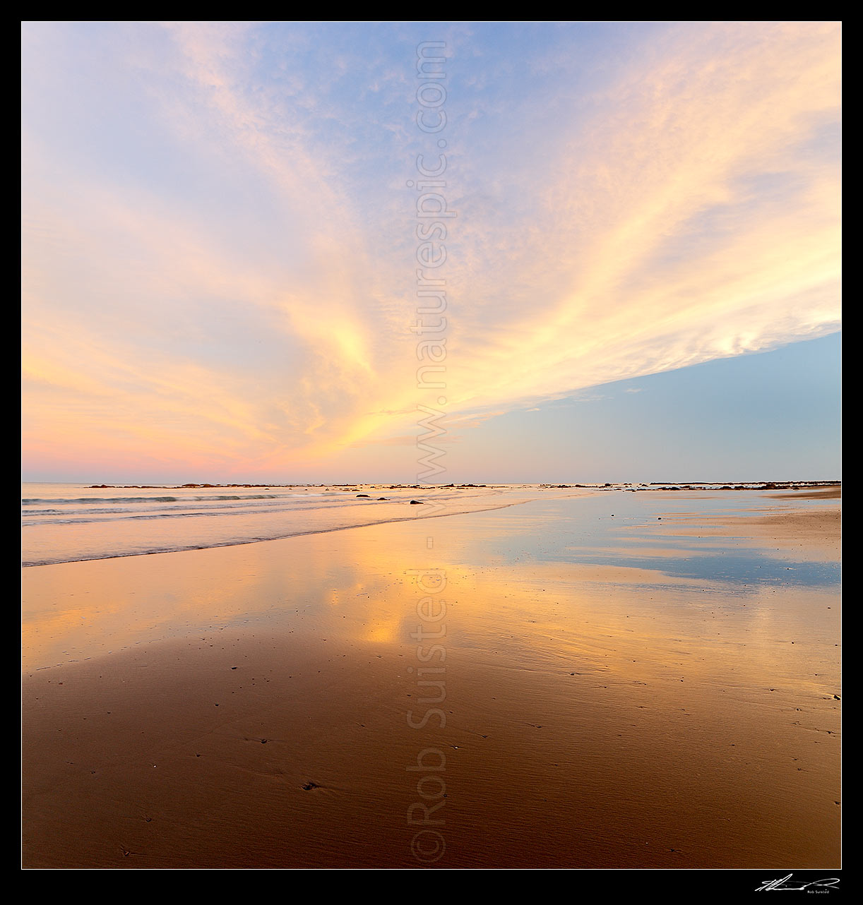 Image of Golden wispy sunest clouds reaching across sky and reflecting in beach sands of Port Awanui. Square format, Port Awanui, East Coast, Gisborne District, Gisborne Region, New Zealand (NZ) stock photo image