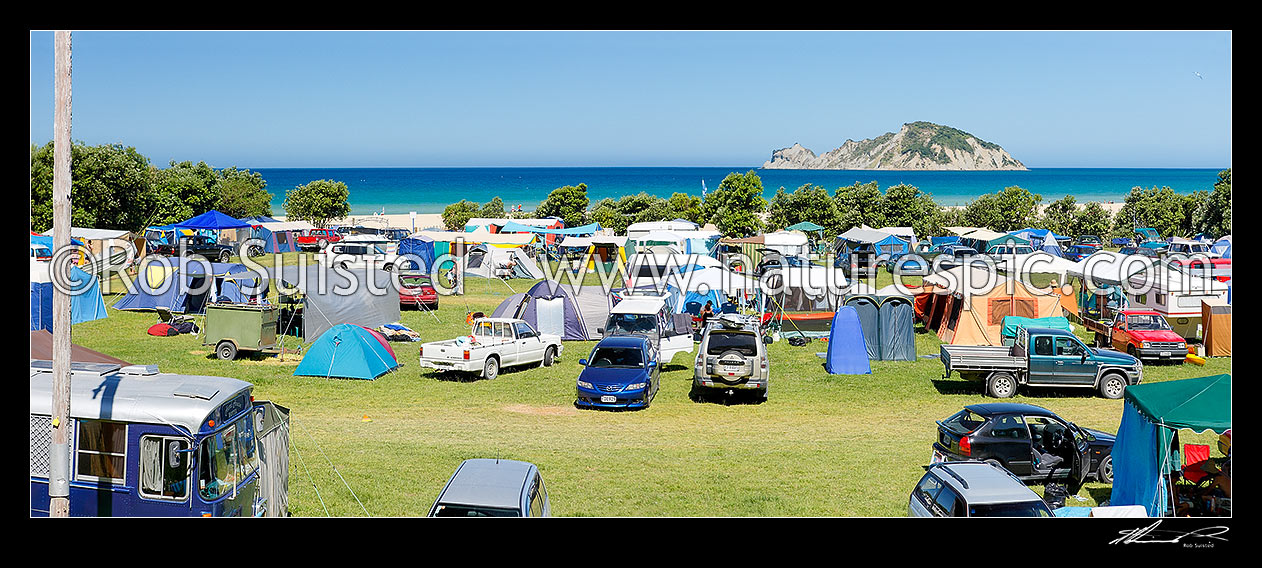 Image of Anaura Bay Recreation Reserve DOC campsite. People enjoying summer holidays, boating, camping, the beach and sun. Panorama, Anaura Bay, Gisborne District, Gisborne Region, New Zealand (NZ) stock photo image