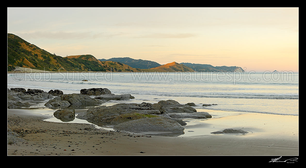 Image of Sunrise at Port Awanui and Te Wharau Beach. Waiapa River mouth centre right, Waikori Bluff and East Island (Whangaokeno) far right. Panorama, Port Awanui, East Coast, Gisborne District, Gisborne Region, New Zealand (NZ) stock photo image