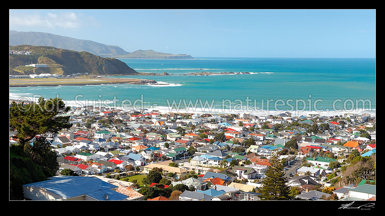 Image of Wellington South Coast panorama, Lyall Bay suburb and houses, Moa Point, with fishing boat leaving harbour entrance, Pencarrow Head and Cook Strait beyond, Wellington South Coast, Wellington City District, Wellington Region, New Zealand (NZ) stock photo image