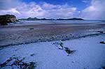 Snow on creek and sand by beach