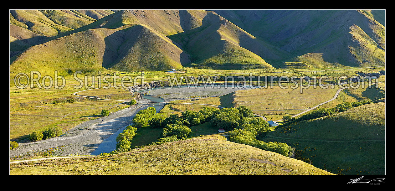 Image of Acheron Accomodation House (historic), road bridge and Clarence River panorama on a lush summer evening, Molesworth Station, Marlborough District, Marlborough Region, New Zealand (NZ) stock photo image