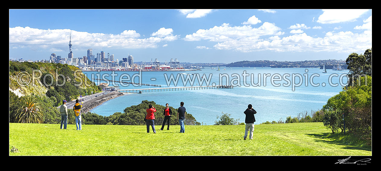 Image of Asian tourists taking photos of Auckland City, waterfront and Waitemata Harbour near Mission Bay, with ferries and yachts behind. Bastion Point. Panorama, Auckland City, Auckland City District, Auckland Region, New Zealand (NZ) stock photo image