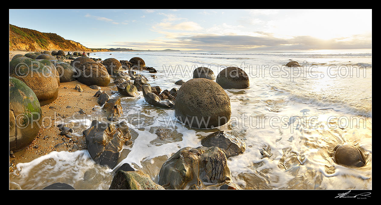 Image of Moeraki Boulders / Kaihinaki, 60 Million year old mudstone concretions in waves. A well known tourist destination. Panorama, Moeraki, Waitaki District, Canterbury Region, New Zealand (NZ) stock photo image