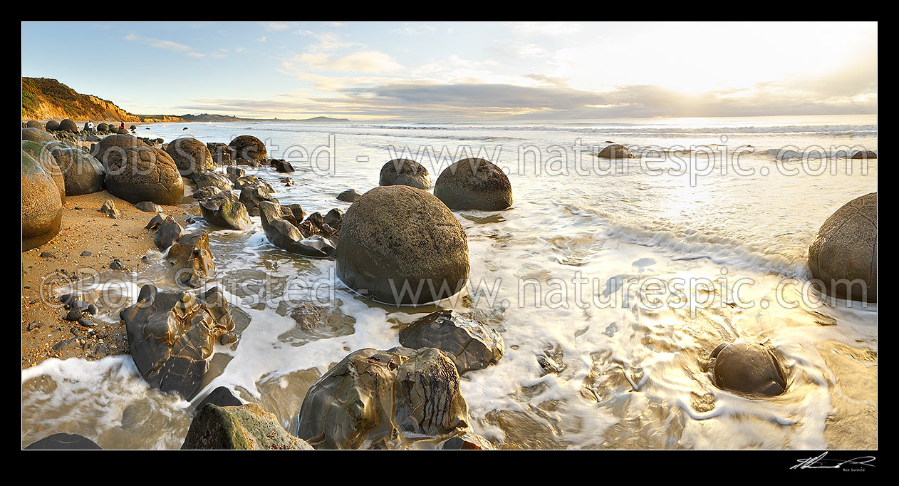 Image of Moeraki Boulders / Kaihinaki, 60 Million year old mudstone concretions in waves. A well known tourist destination. Panorama, Moeraki, Waitaki District, Canterbury Region, New Zealand (NZ) stock photo image