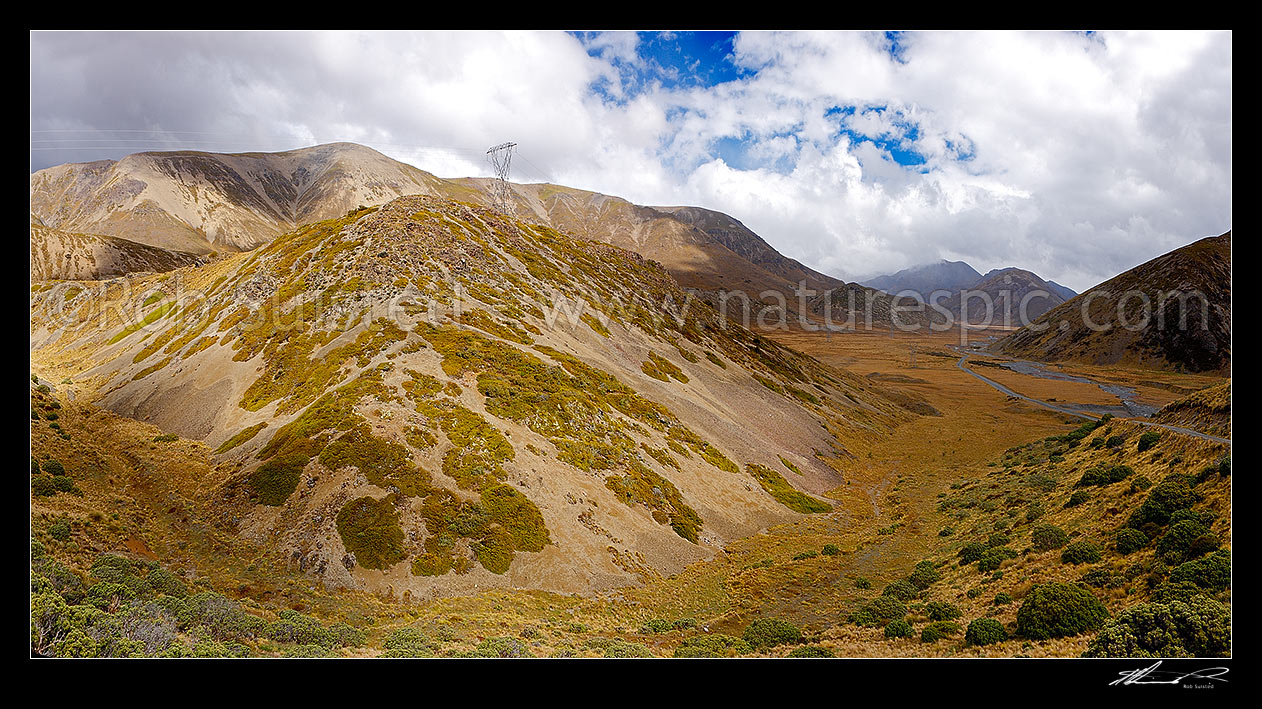 Image of Island Saddle with Wairau - Hanmer Springs Hydro Road descending towards Lake Tennyson. Island Pass and Paget Ridge left, St James Range right. Panorama, Molesworth Station, Marlborough District, Marlborough Region, New Zealand (NZ) stock photo image