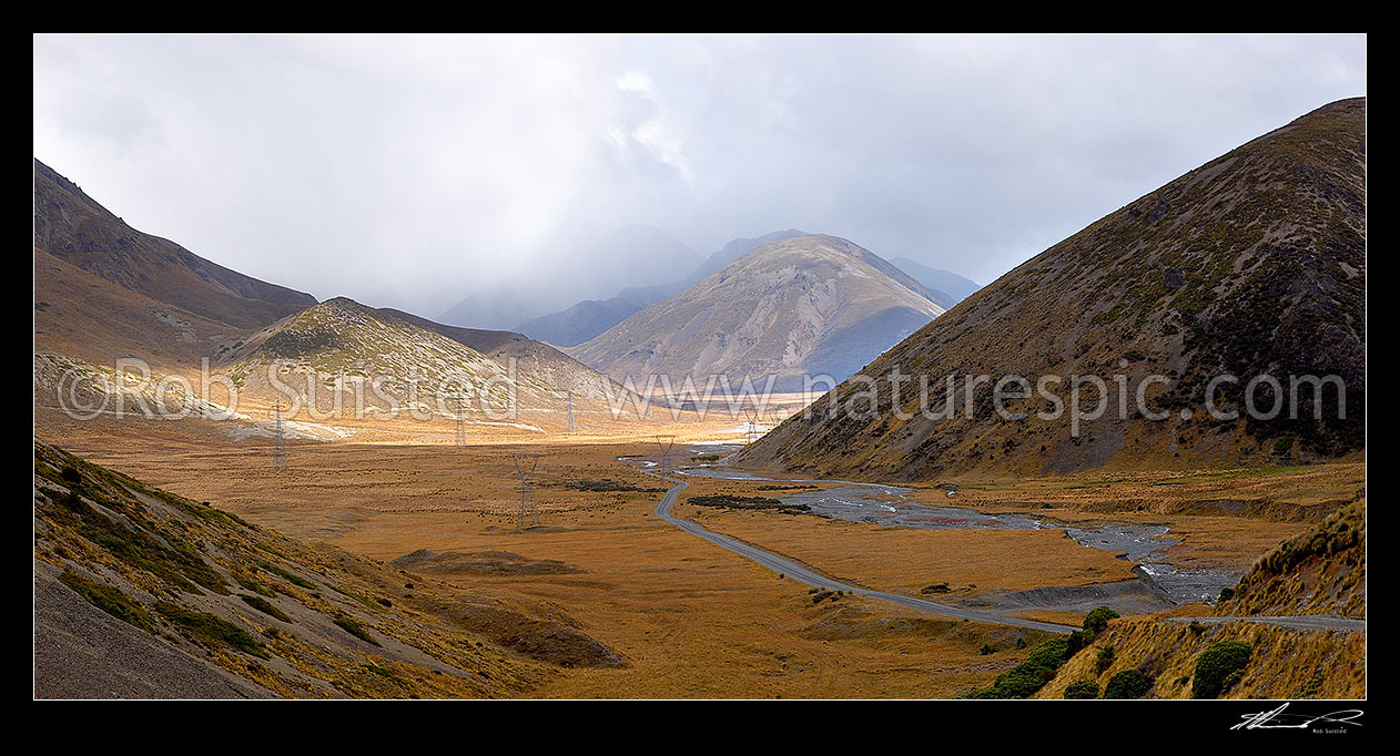 Image of Island Saddle with Wairau - Hanmer Springs Hydro Road and power pylons descending towards Lake Tennyson. St James Range distant. Panorama, Molesworth Station, Marlborough District, Marlborough Region, New Zealand (NZ) stock photo image