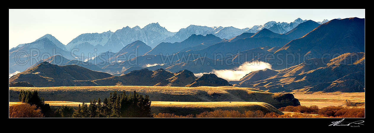 Image of Mount Tapuae-o-Uenuku (2885m) and Inland Kaikoura Ranges panorama on a calm golden Autumn morning as mist lifts from valleys, Molesworth Station, Marlborough District, Marlborough Region, New Zealand (NZ) stock photo image