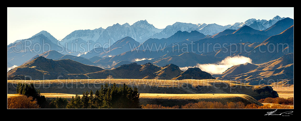 Image of Mount Tapuae-o-Uenuku (2885m) and Inland Kaikoura Ranges panorama on a calm golden Autumn morning as mist lifts from valleys, Molesworth Station, Marlborough District, Marlborough Region, New Zealand (NZ) stock photo image